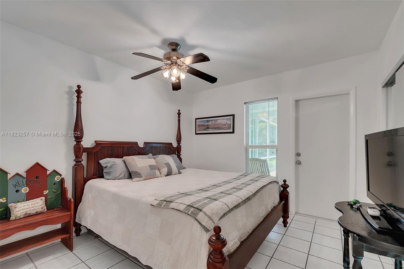 7340 Southwest 123rd Terrace Pinecrest, FL 33156 - Photo 17 of 30 a bedroom with a large bed and a tv