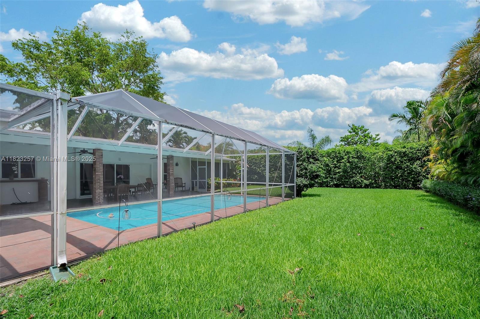 7340 Southwest 123rd Terrace Pinecrest, FL 33156 - Photo 25 of 30 a view of a house with backyard and porch