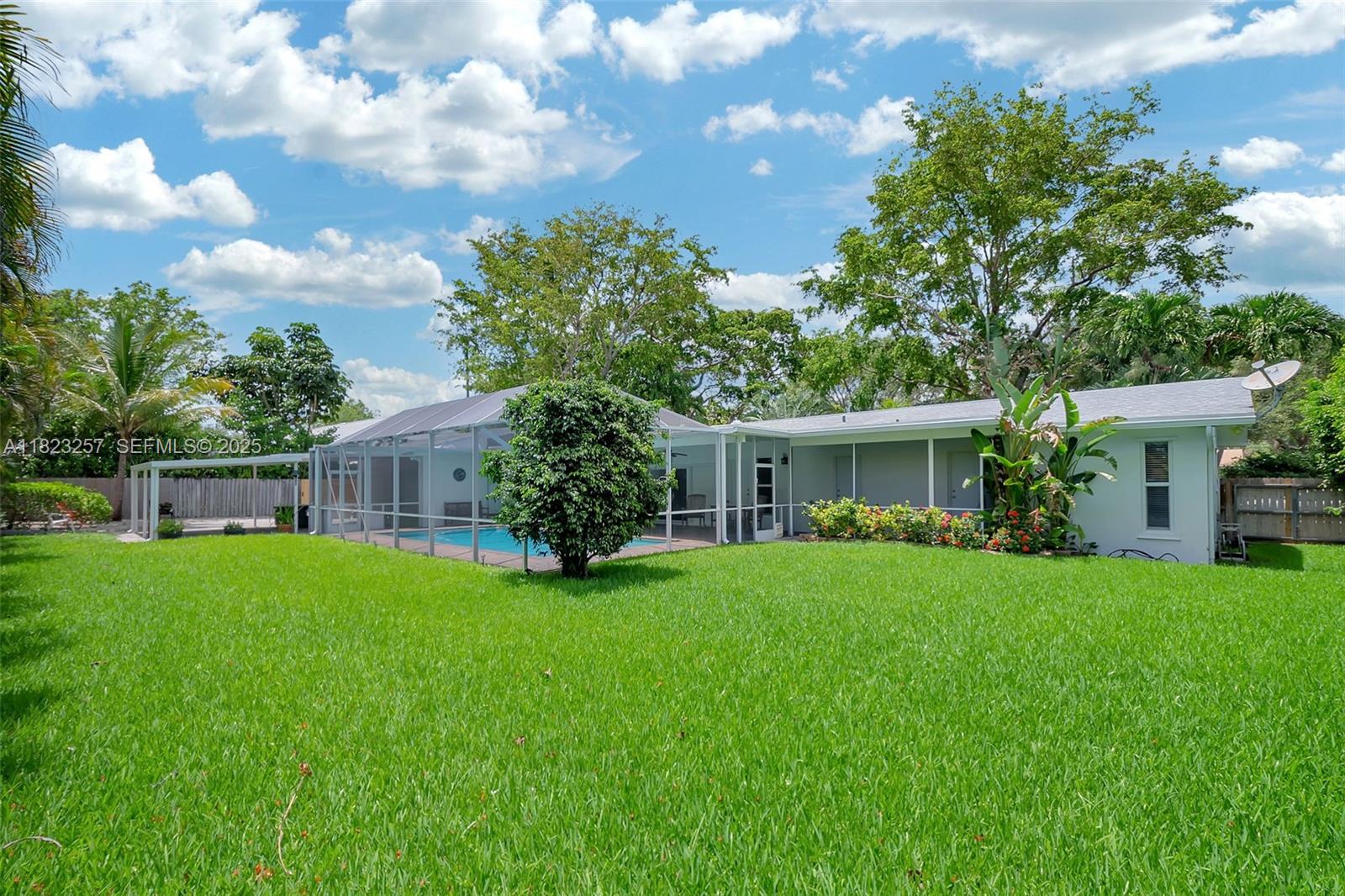 7340 Southwest 123rd Terrace Pinecrest, FL 33156 - Photo 26 of 30 a view of a house with a big yard and a large tree