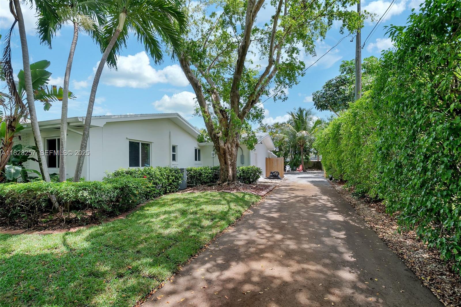 7340 Southwest 123rd Terrace Pinecrest, FL 33156 - Photo 27 of 30 a front view of a house with a garden