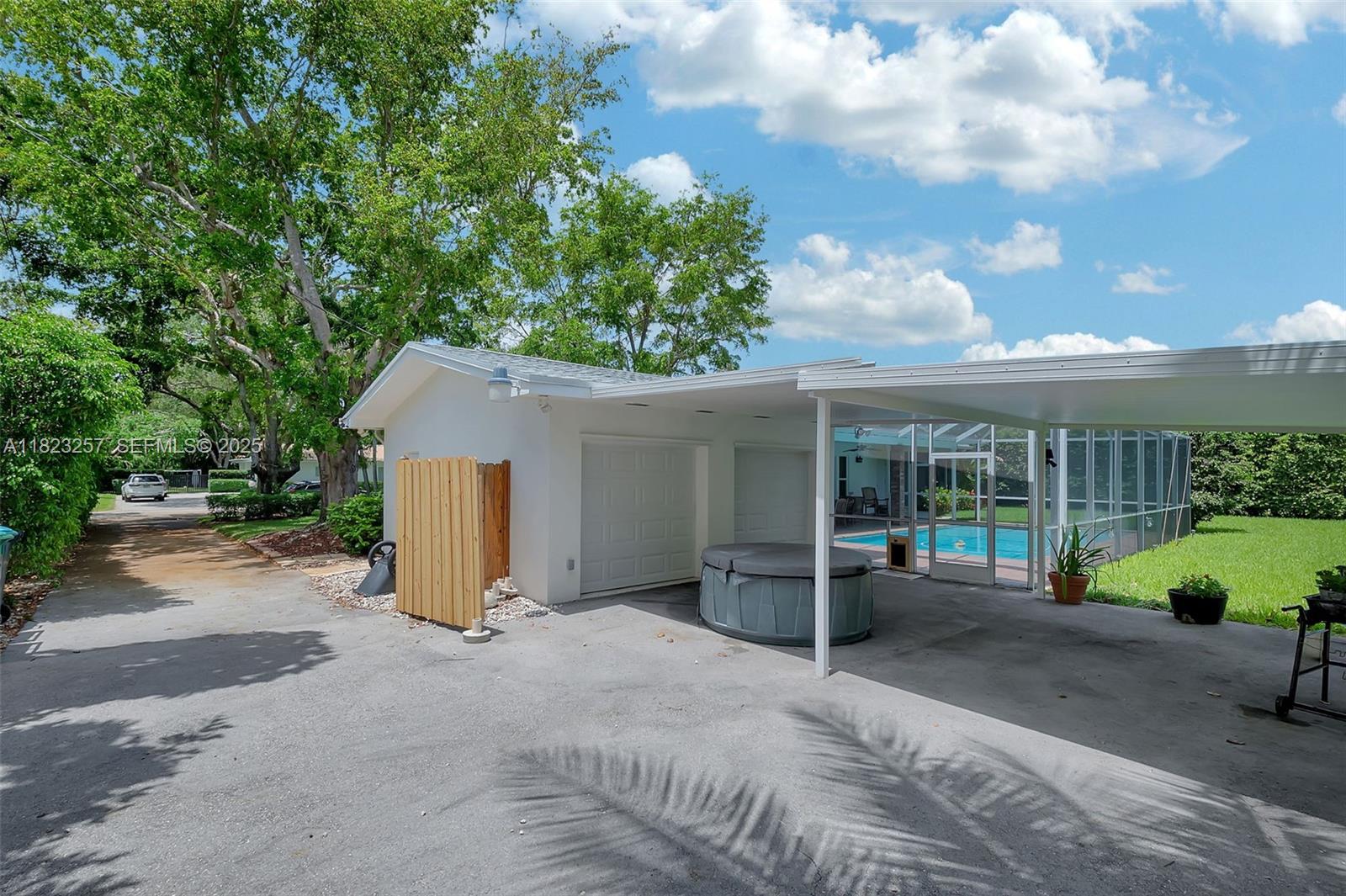 7340 Southwest 123rd Terrace Pinecrest, FL 33156 - Photo 28 of 30 a view of a house with porch and garden