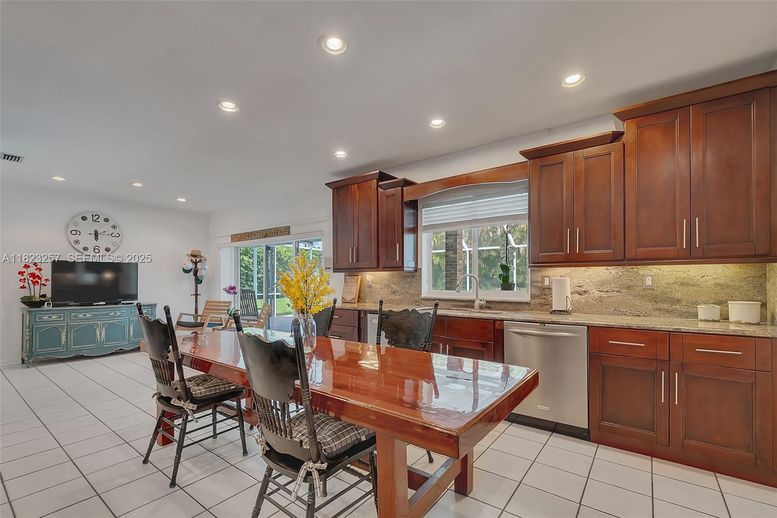 7340 Southwest 123rd Terrace Pinecrest, FL 33156 - Photo 10 of 30 a dining hall with stainless steel appliances granite countertop a table and chairs