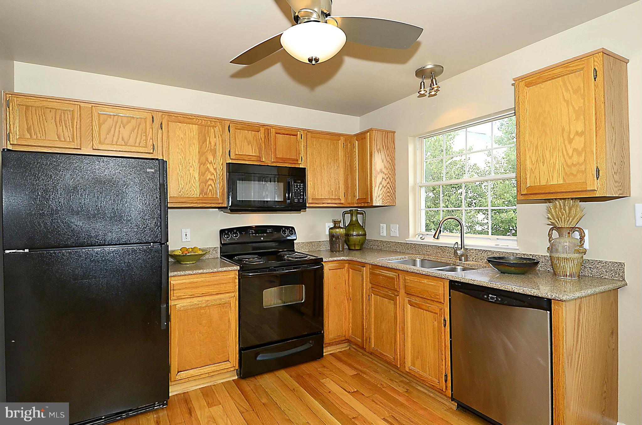 6405 Racetec Court Springfield, VA 22150 - Photo 9 of 30 a kitchen with a sink a window stainless steel appliances and cabinets