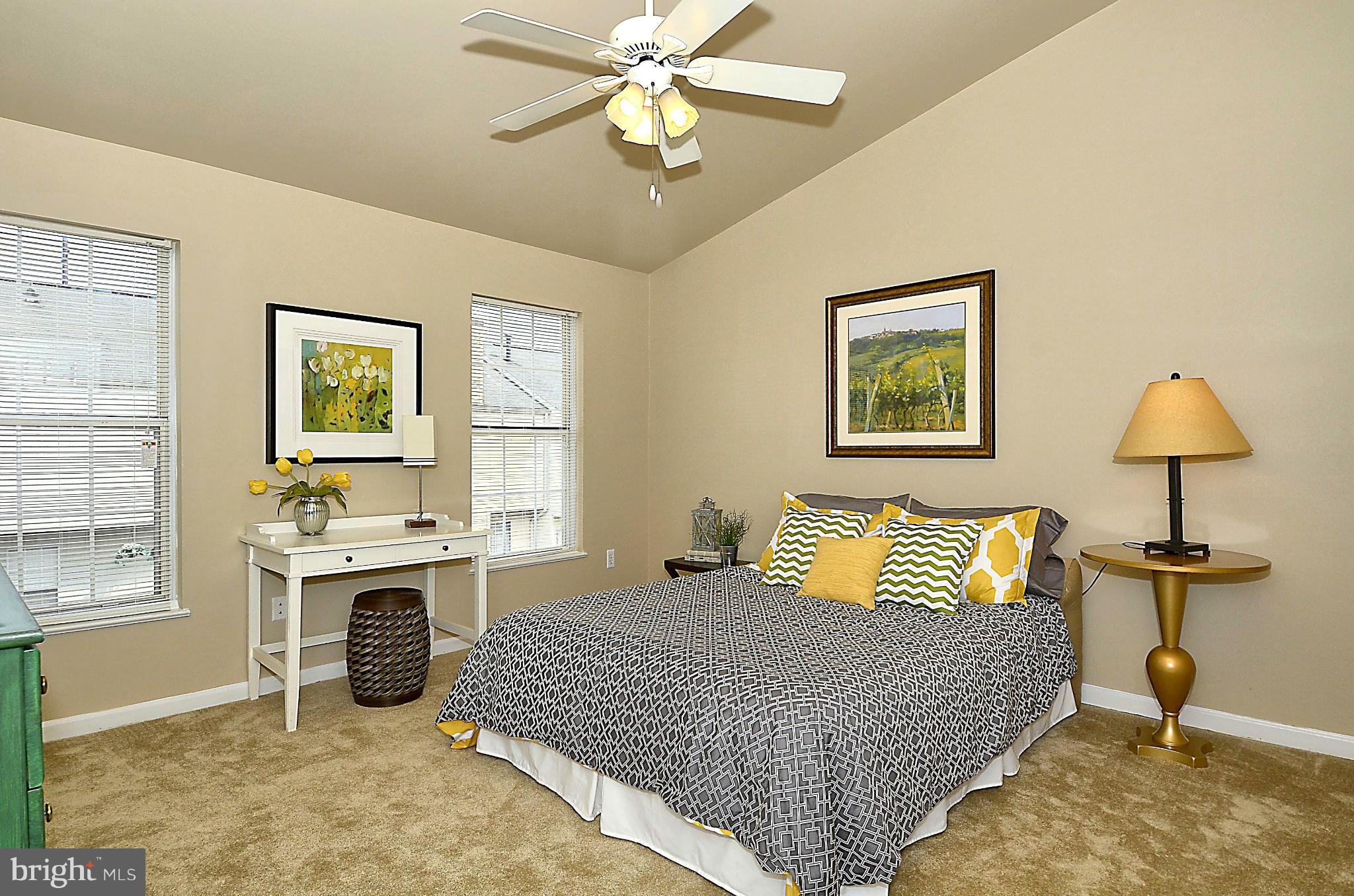 6405 Racetec Court Springfield, VA 22150 - Photo 12 of 30 a bedroom with a bed and a chandelier