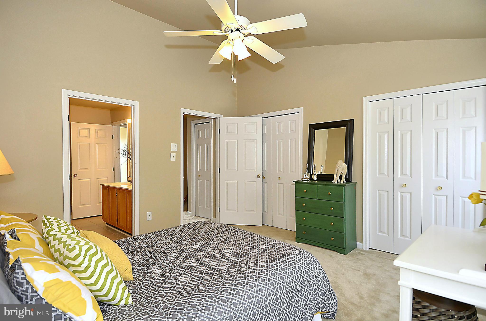 6405 Racetec Court Springfield, VA 22150 - Photo 13 of 30 a bedroom with a bed and a chandelier