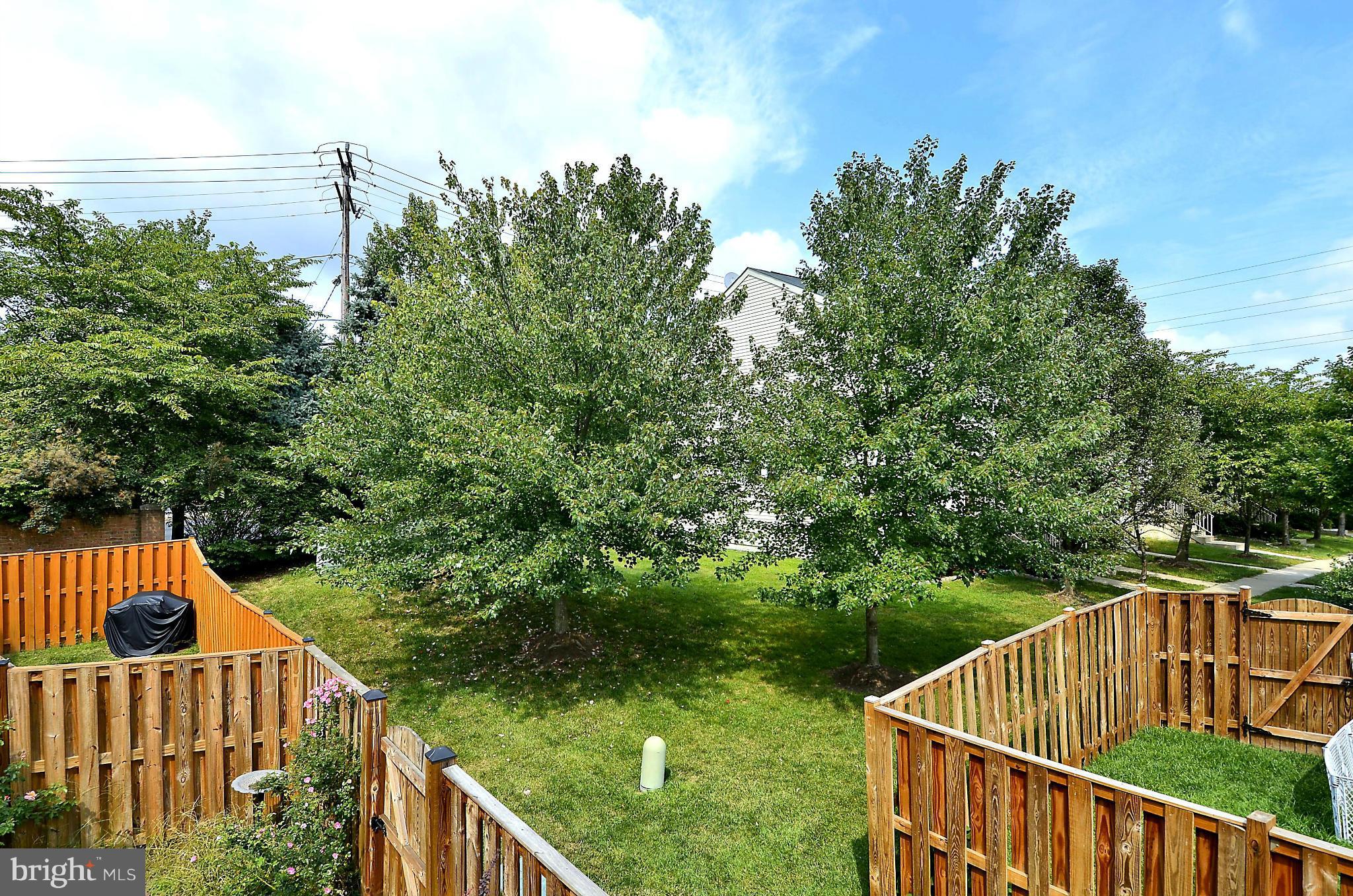 6405 Racetec Court Springfield, VA 22150 - Photo 23 of 30 a view of a roof deck with chair and wooden floor