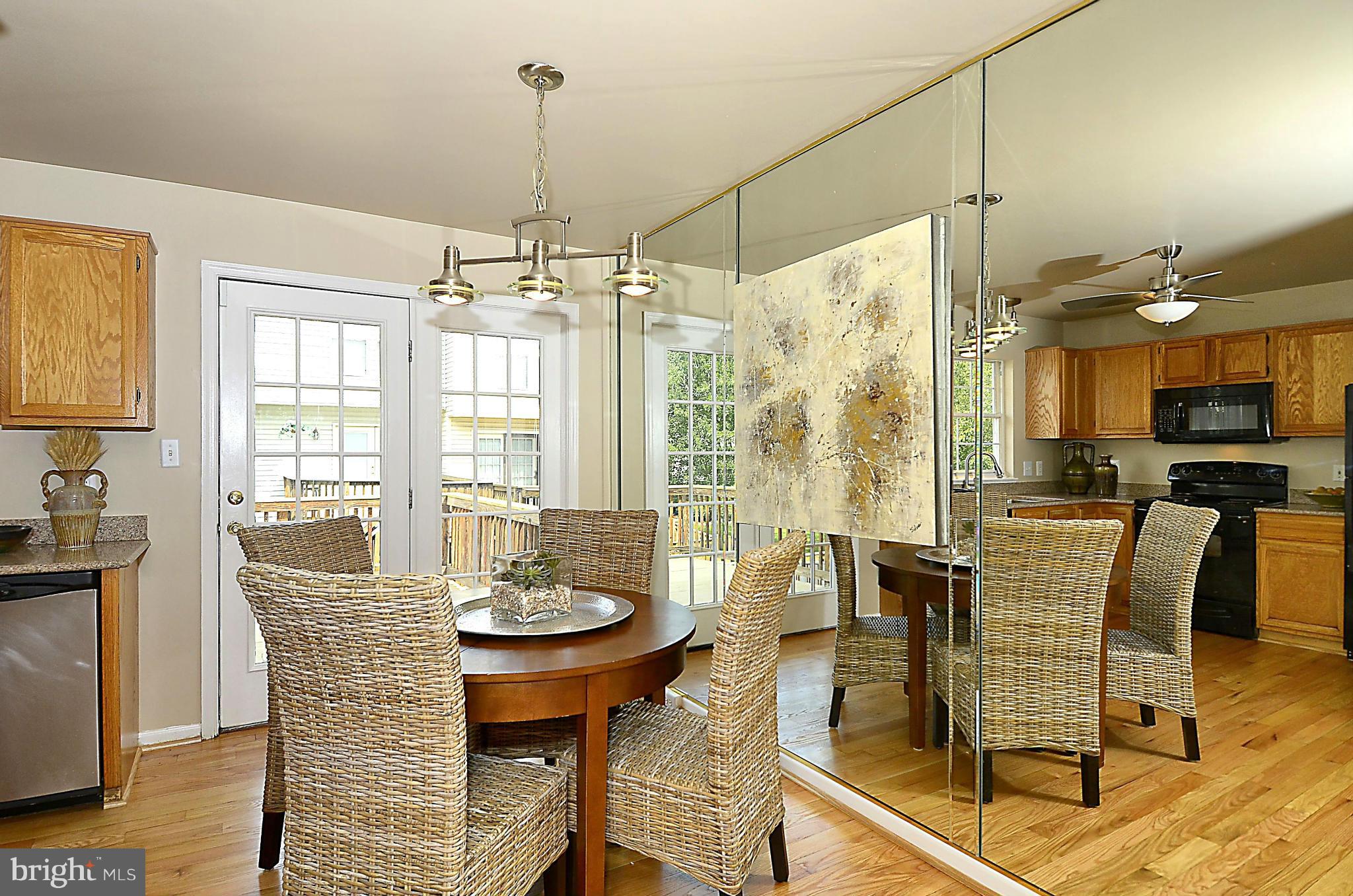 6405 Racetec Court Springfield, VA 22150 - Photo 7 of 30 a view of a dining room with furniture window and wooden floor