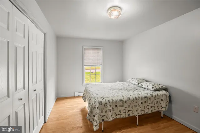 a bedroom with a bed and window