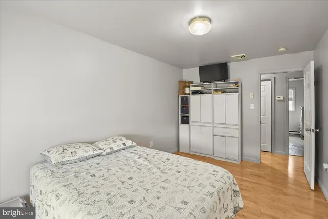 a bedroom with a bed and a television