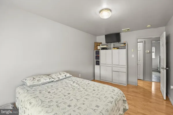 a bedroom with a bed and a television