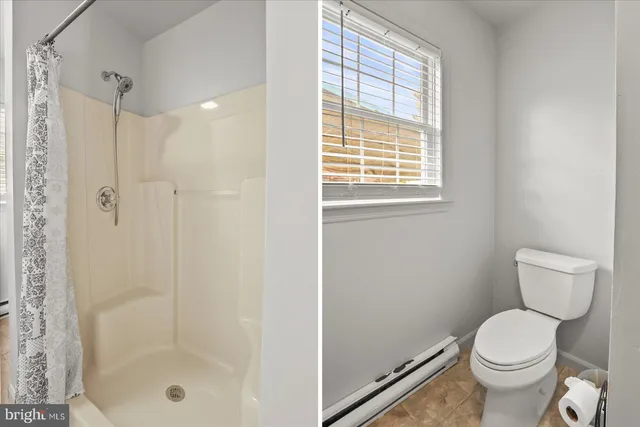 a bathroom with a shower and a toilet