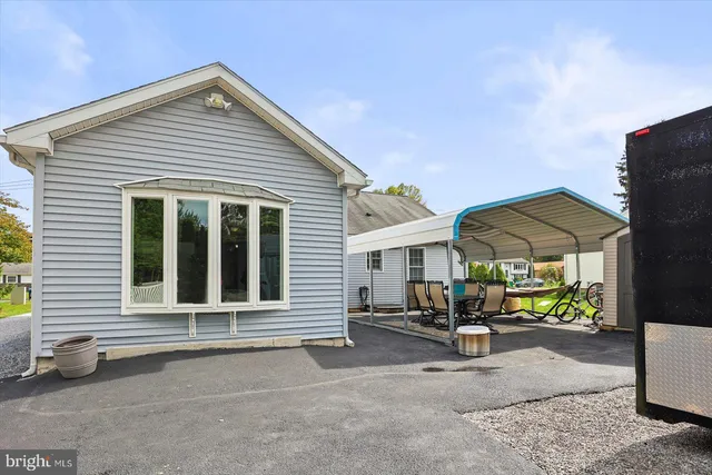 a view of a house with sitting area and garden