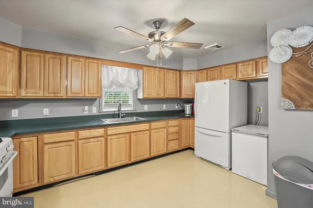 a kitchen with refrigerator a sink and cabinets