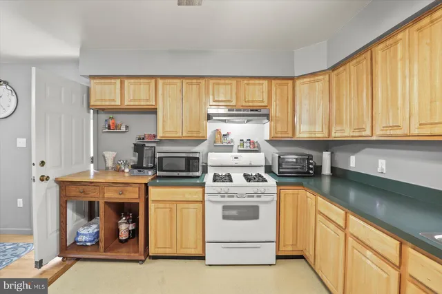 a kitchen with stove and cabinets
