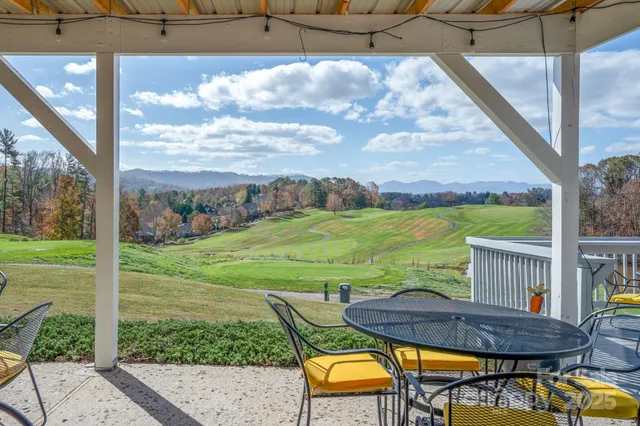 a view of a chairs and table in patio with a yard