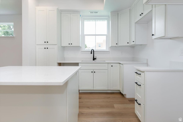 314 North 200 West Logan, UT 84321 - Photo 6 of 37 Kitchen with white cabinetry and light wood-type flooring