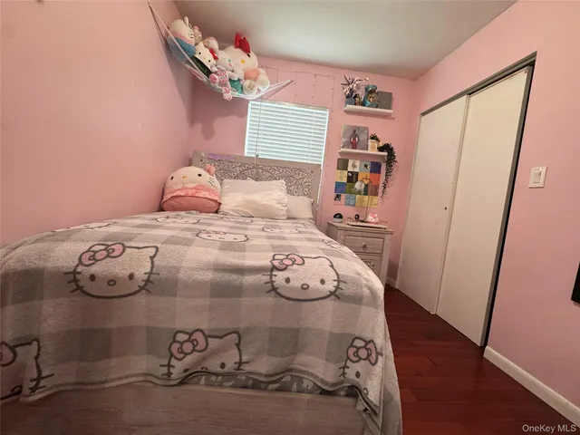 a bedroom with a bed and a mirror