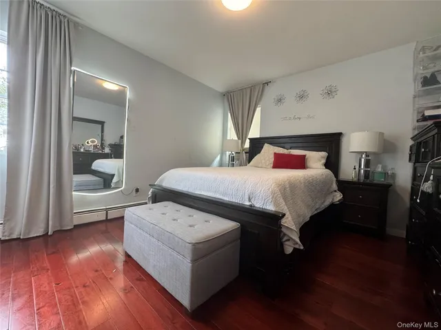 a bedroom with a bed and a view of kitchen