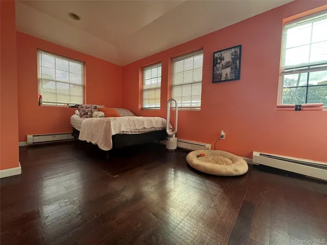 a bed sitting in a room next to a window