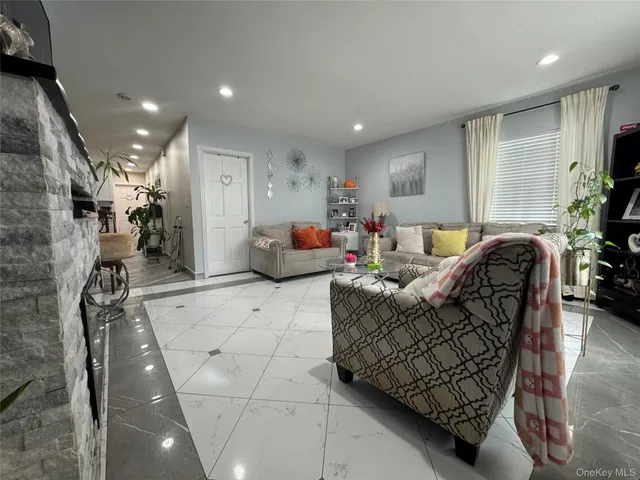 a living room with furniture and a potted plant