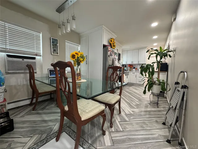 a view of a room with furniture and wooden floor