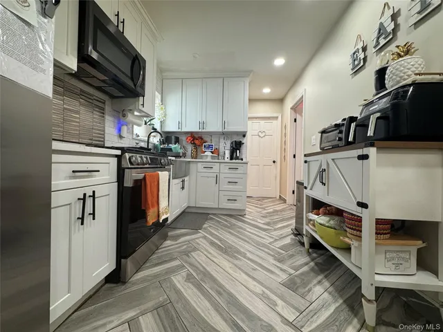 a kitchen with stainless steel appliances a stove and a refrigerator