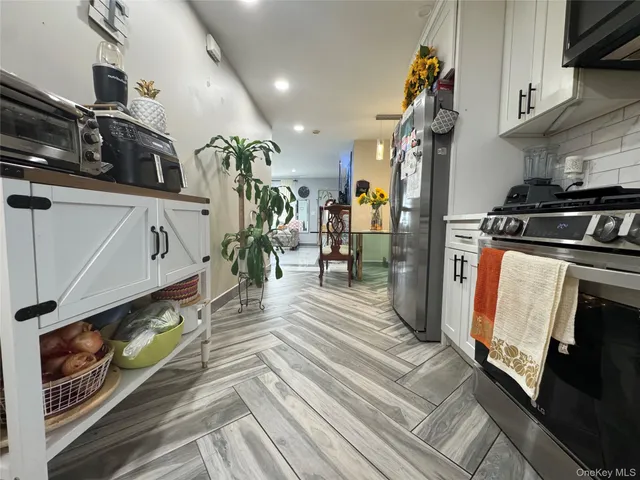 a kitchen with stainless steel appliances granite countertop a stove and a sink