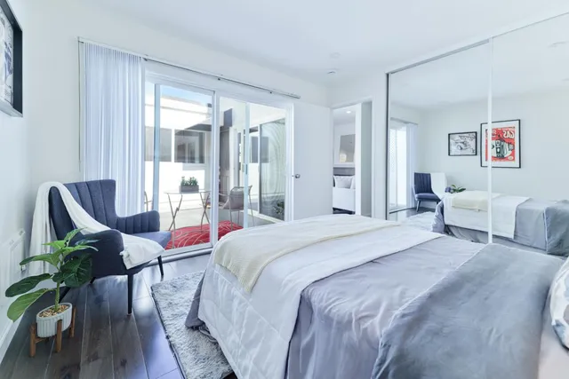 a bedroom with a bed and a chair