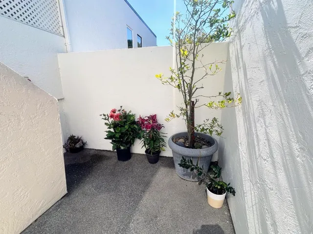 a view of a house with backyard fountain and sitting area