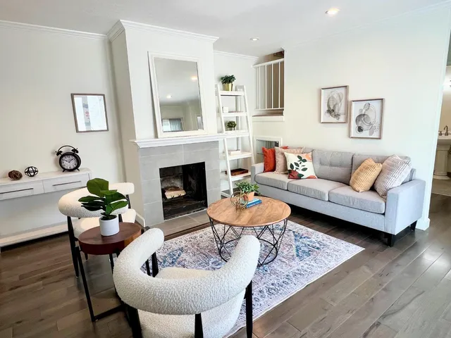 a living room with furniture and a fireplace