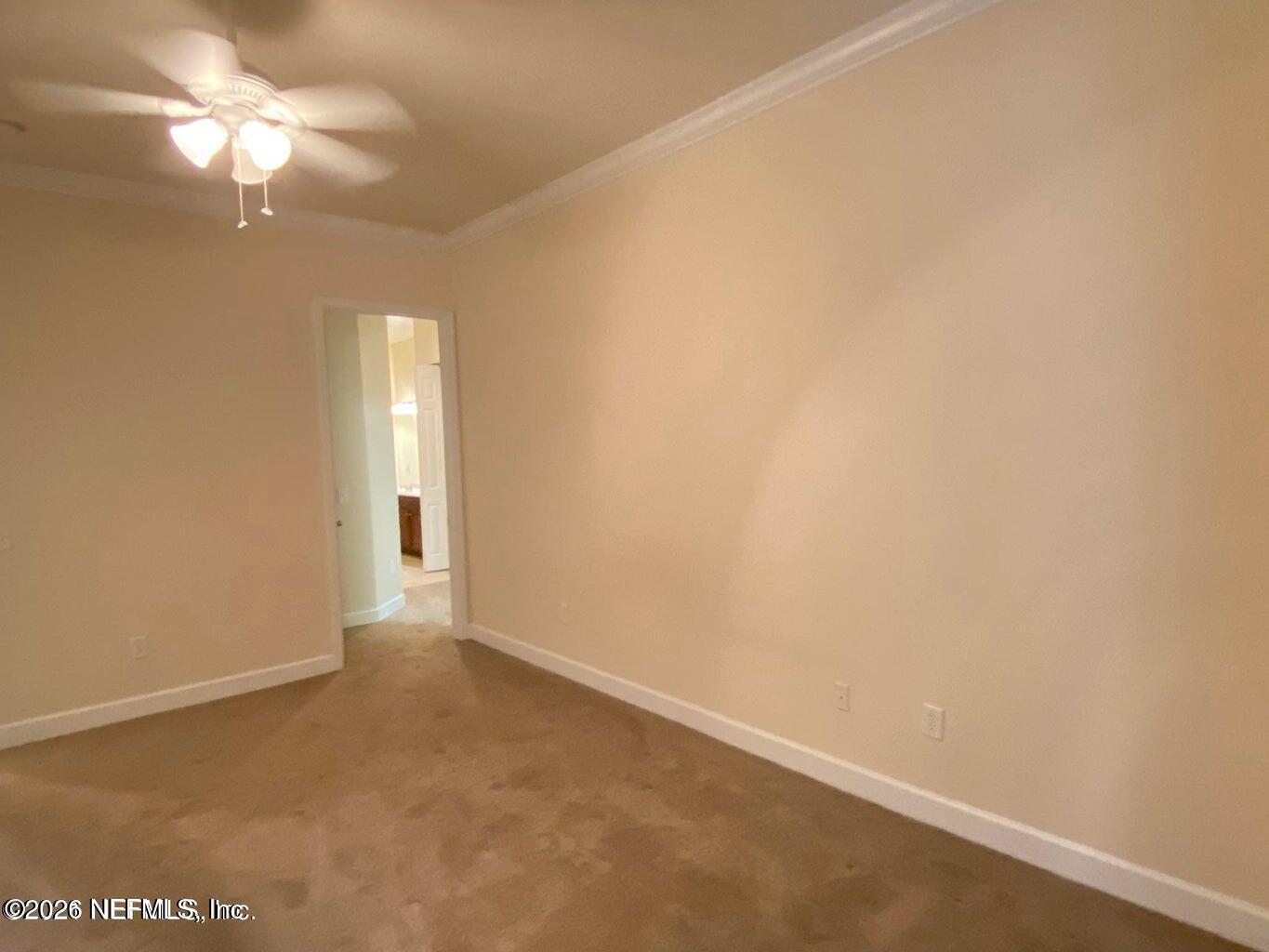 2035 Secret Garden Lane, Unit 504 Fleming Island, FL 32003 - Photo 11 of 32 an empty room with a empty space and a ceiling fan