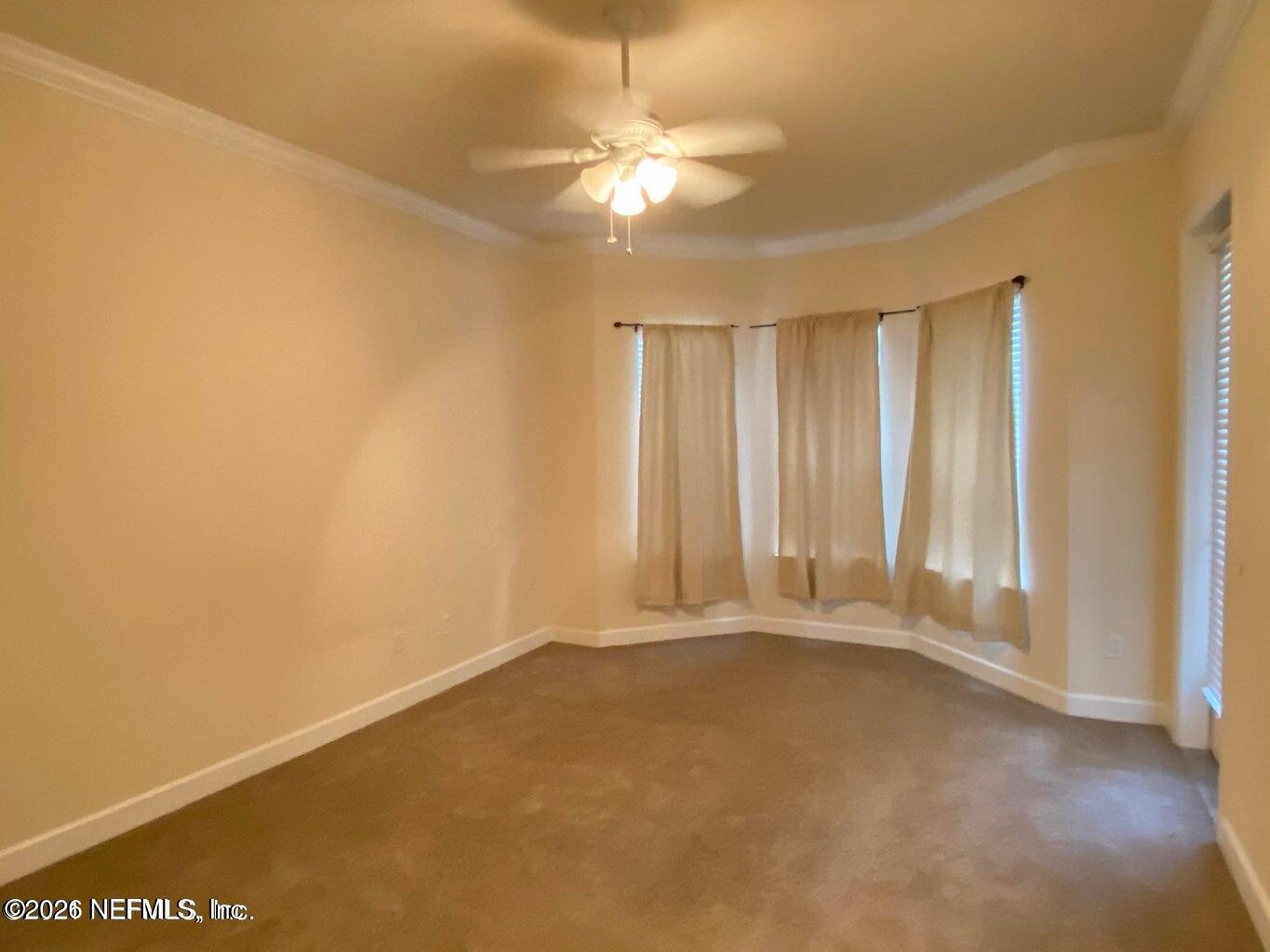 2035 Secret Garden Lane, Unit 504 Fleming Island, FL 32003 - Photo 12 of 32 an empty room with a ceiling fan and window