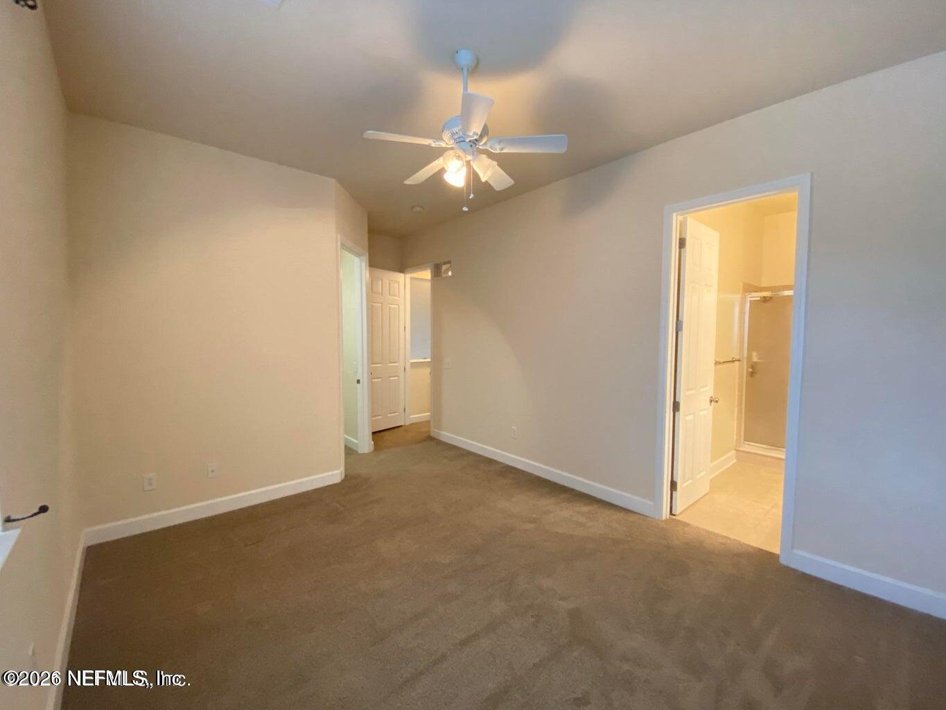 2035 Secret Garden Lane, Unit 504 Fleming Island, FL 32003 - Photo 21 of 32 an empty room with a ceiling fan and a window