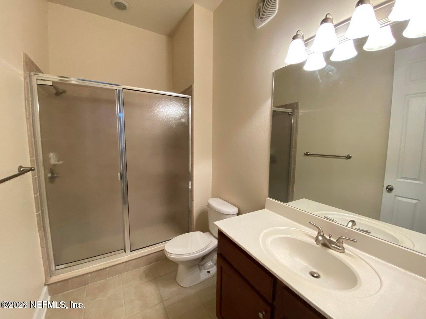 2035 Secret Garden Lane, Unit 504 Fleming Island, FL 32003 - Photo 22 of 32 a bathroom with a sink toilet and shower