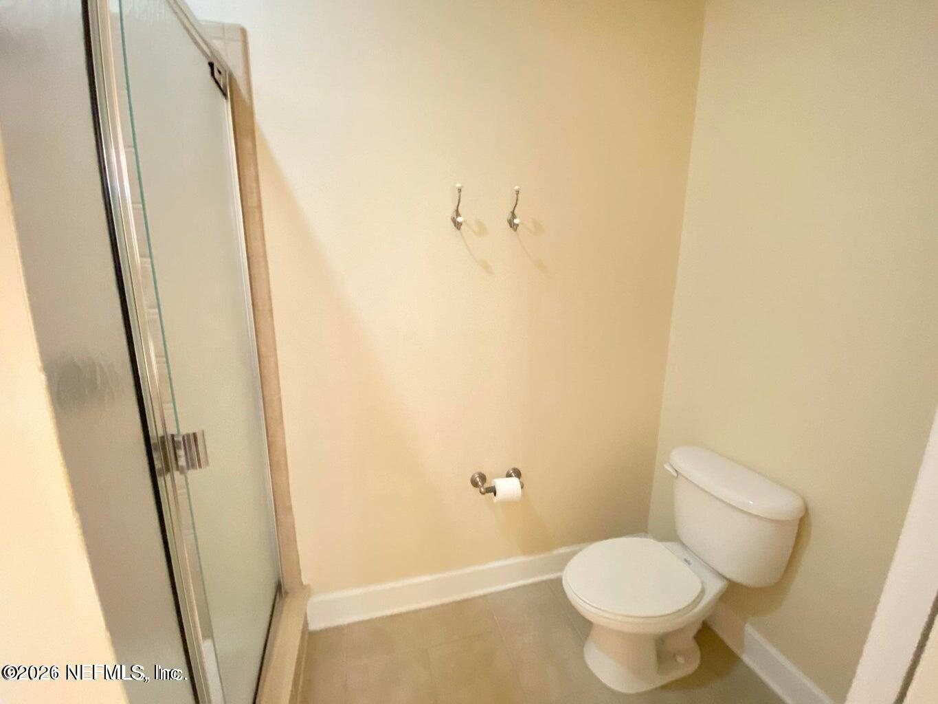 2035 Secret Garden Lane, Unit 504 Fleming Island, FL 32003 - Photo 5 of 32 a bathroom with a toilet and a shower