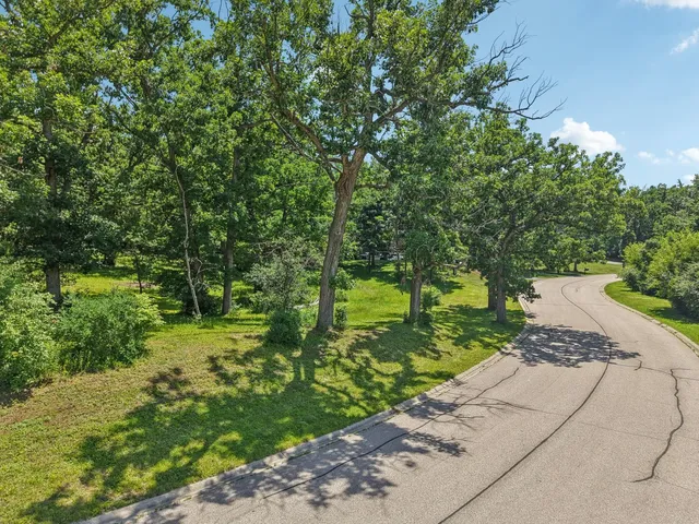 a view of a street with a small yard