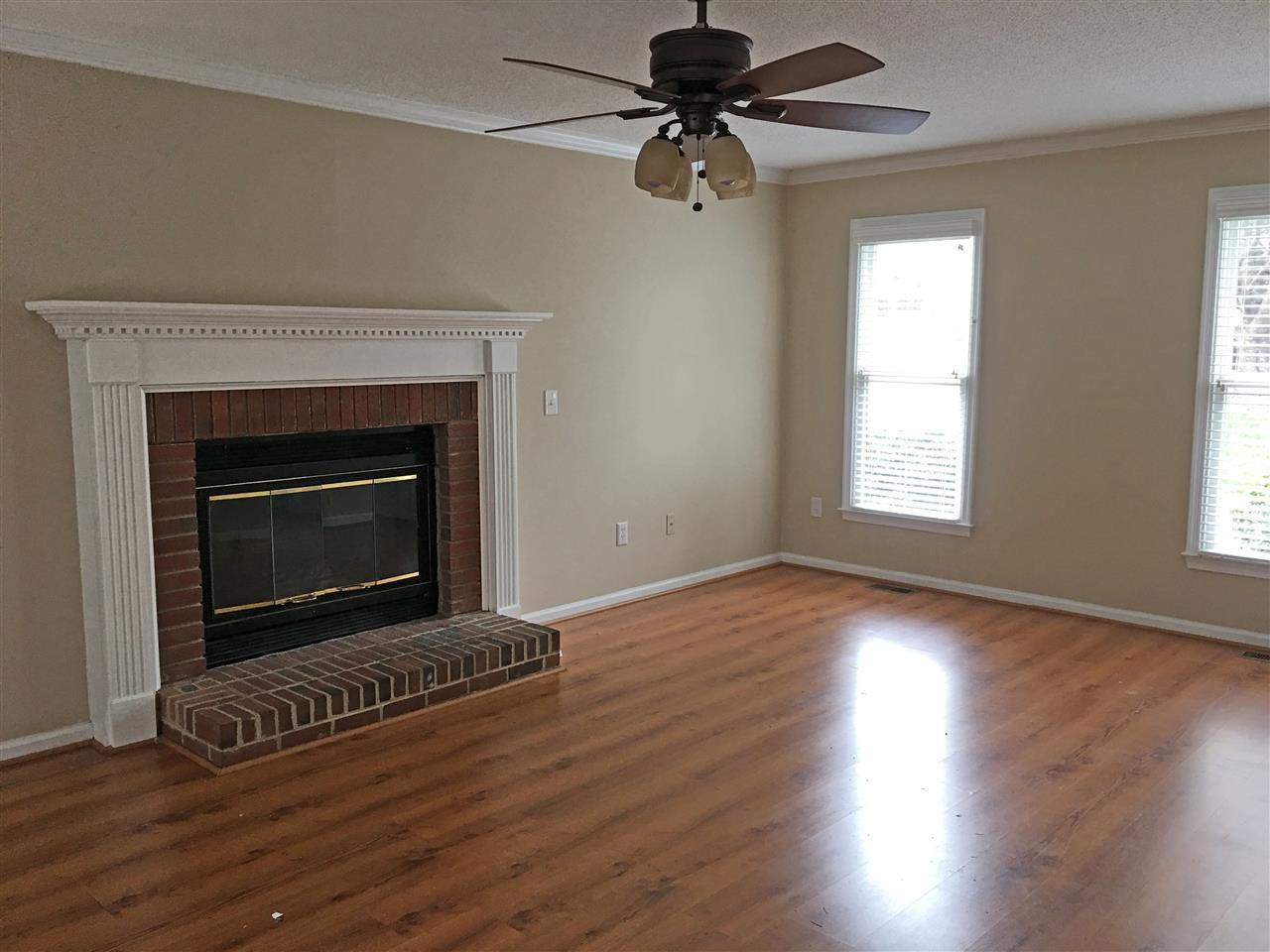 2 Hitching Rack Court Durham, NC 27713 - Photo 7 of 23 Two windows allow sun to shine on wide plank laminate floors. Living Room