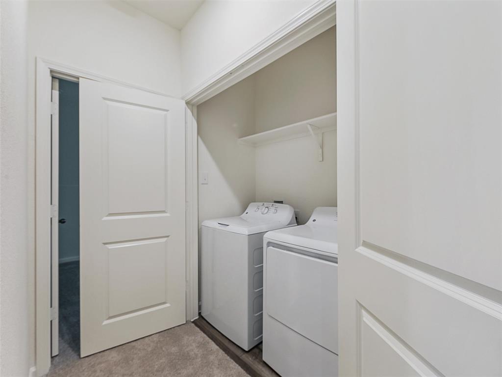 4510 Winecup Road Melissa, TX 75454 - Photo 19 of 22 Dedicated laundry closet featuring a built-in shelf, neutral wall tones, and wood-finish flooring