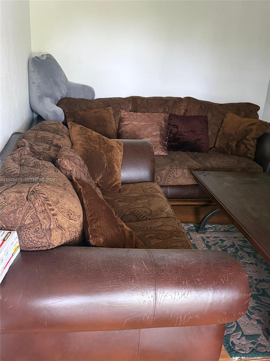 2247 Simms Street, Unit 2 Hollywood, FL 33020 - Photo 6 of 9 a living room with a couch and a lamp with potted plant