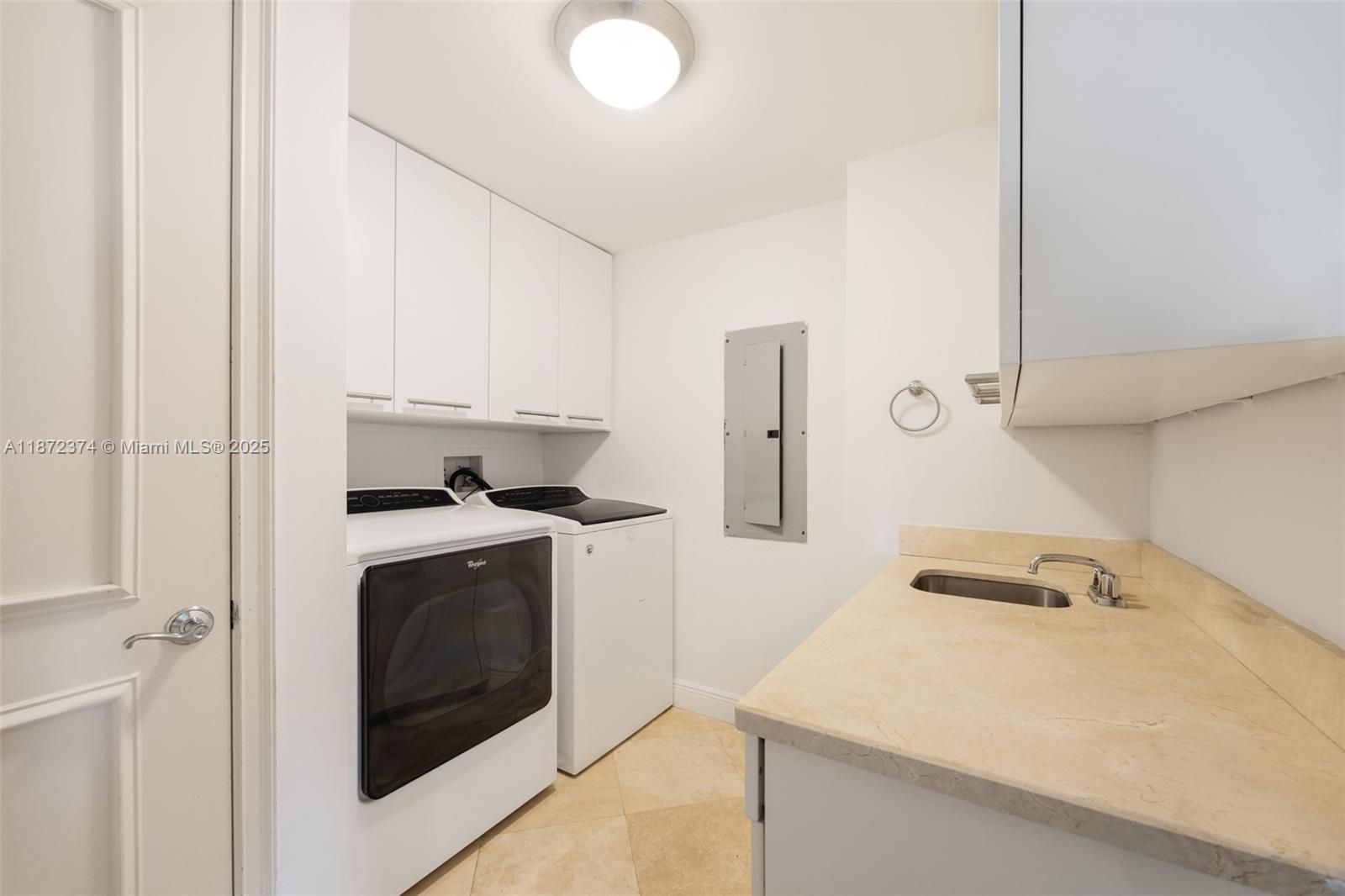 3350 Southwest 27th Avenue, Unit 1402 Miami, FL 33133 - Photo 16 of 23 a kitchen with a stove and a sink