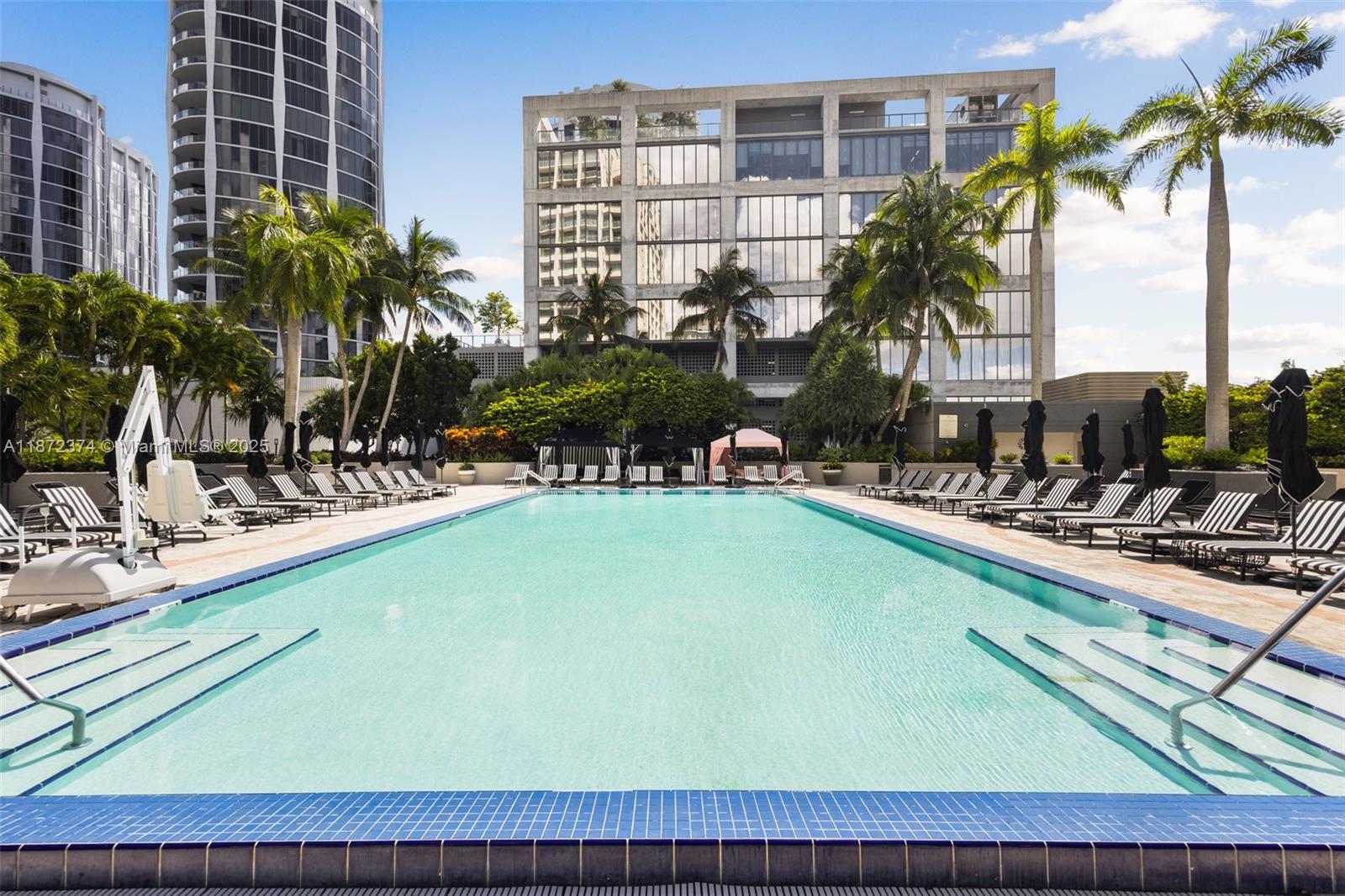 3350 Southwest 27th Avenue, Unit 1402 Miami, FL 33133 - Photo 22 of 23 a view of swimming pool with outdoor seating and a patio
