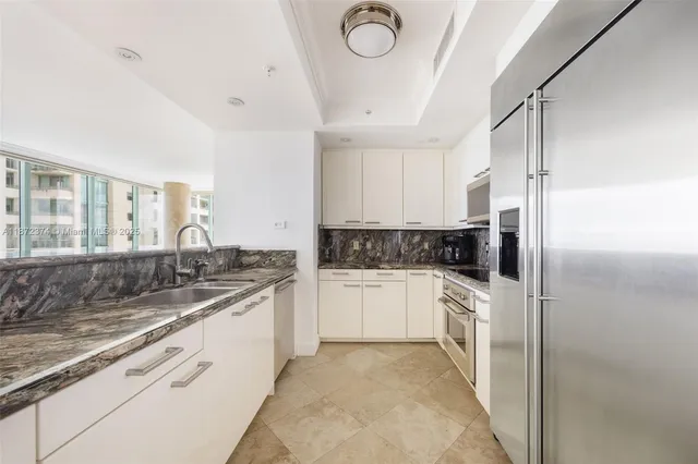 a kitchen with a sink stove and refrigerator