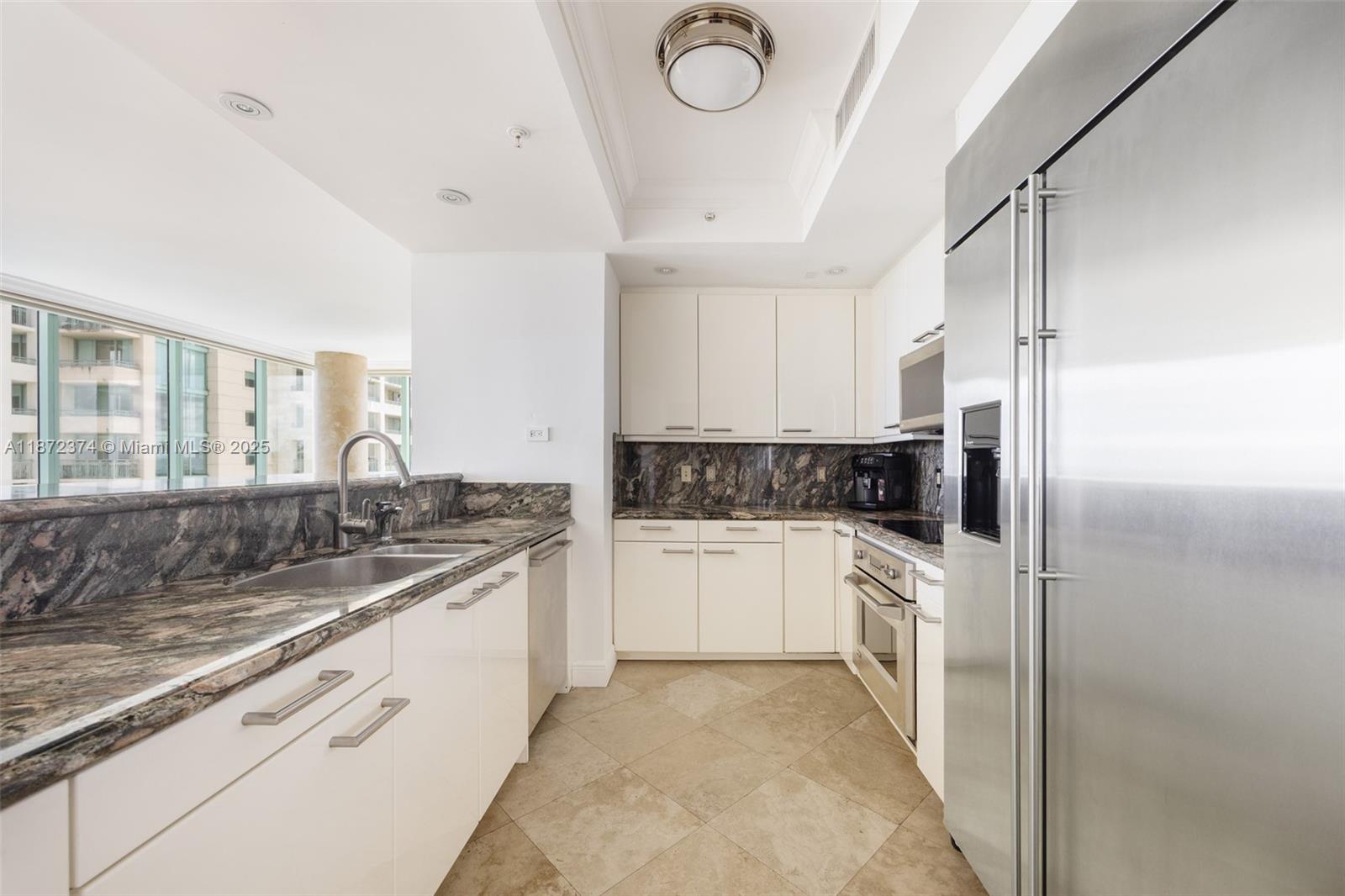 3350 Southwest 27th Avenue, Unit 1402 Miami, FL 33133 - Photo 4 of 23 a kitchen with a sink stove and refrigerator