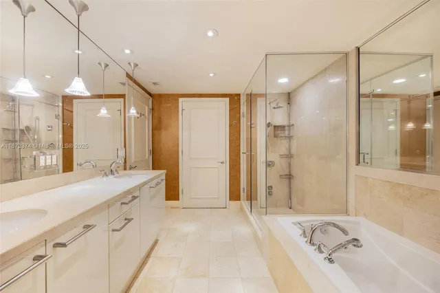 a large bathroom with a tub sink shower and mirror
