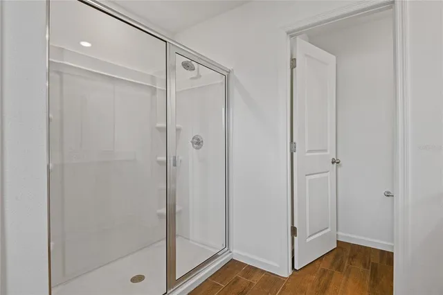 a bathroom with a shower and a glass door