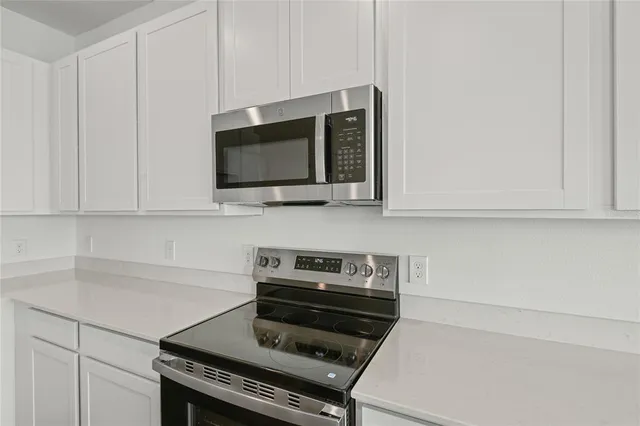 a kitchen with a stove and a microwave