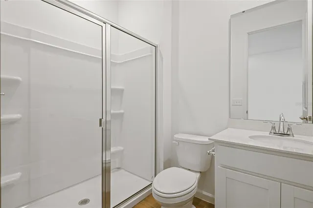 a bathroom with a toilet a sink and shower