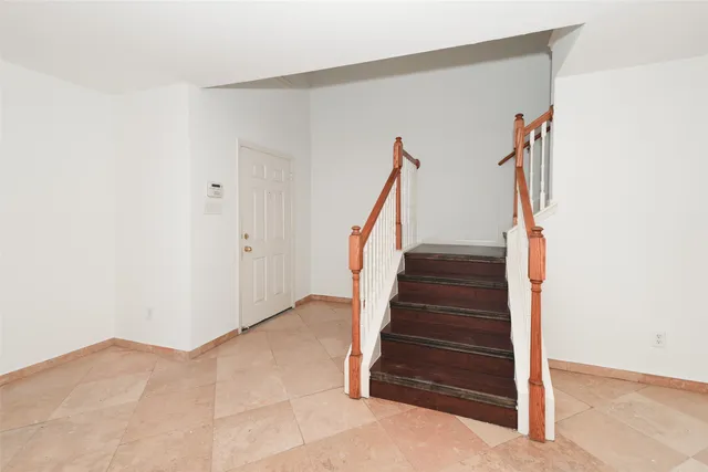 a view of empty room with stairs