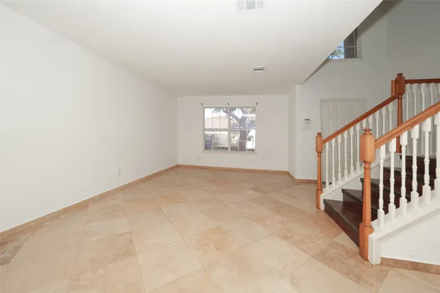 a view of wooden floor and windows in a room