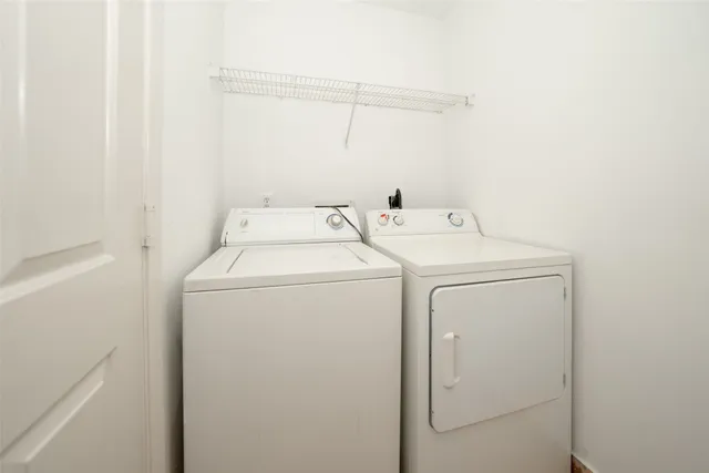 an empty room with windows and fireplace